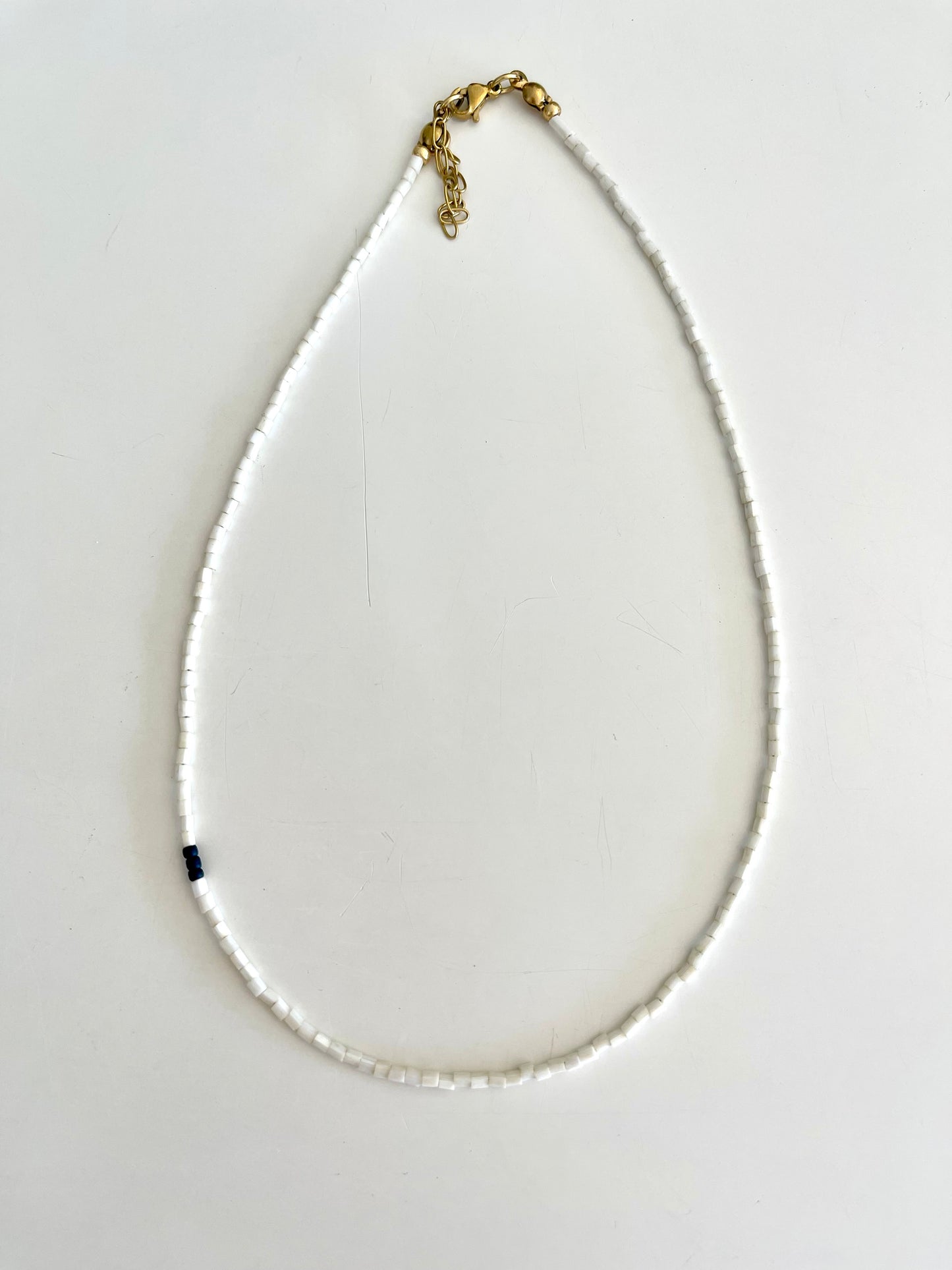 Left of the middle necklace