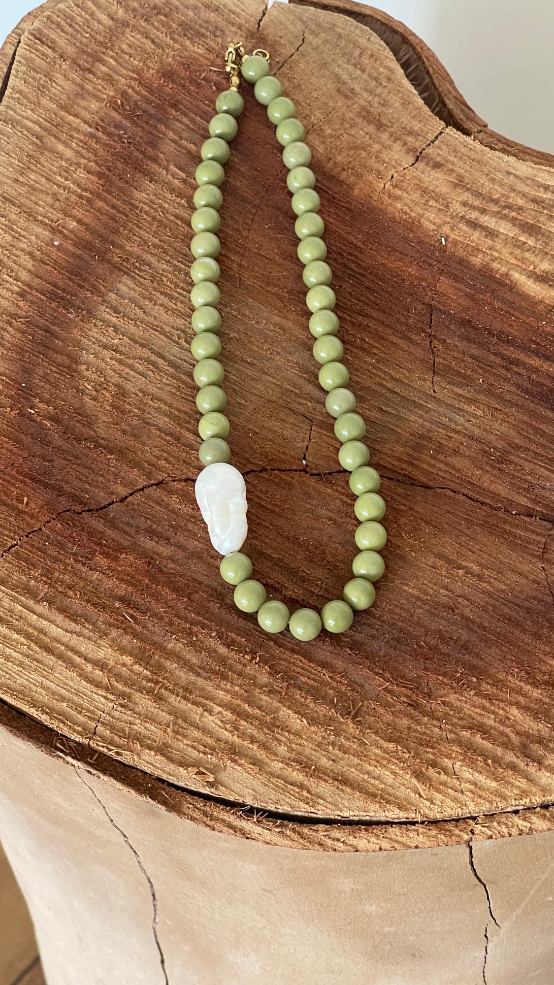 Green beaded necklace with a pearl off centered . Unique design handcrafted by The Loop Store